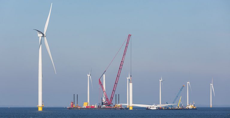 Wide view of the Horns Rev 3 Offshore Wind Farm with wind turbines on the horizon